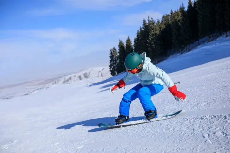 one young woman snowboarding in winter mountains